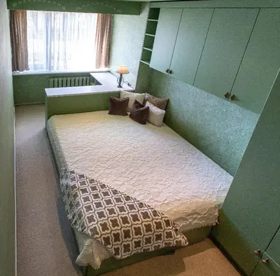a bedroom with a bed in a green room at Gerda Apartments in Druskininkai