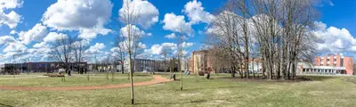 a park with trees and buildings on a cloudy day at Gerda Apartments in Druskininkai