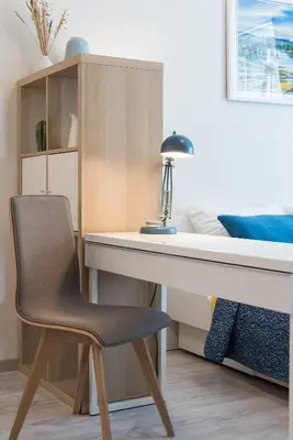 a desk with a chair next to a bed at HaPPy INN Studio Historic center, Self check-in, AC, Parking in the undergrnd Garage, in Vilnius
