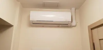 a bathroom with a air conditioner on a wall at HaPPy INN Studio Historic center, Self check-in, AC, Parking in the undergrnd Garage, in Vilnius