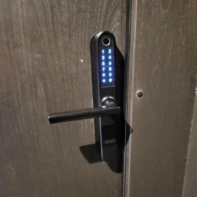 a black door handle with a cell phone on it at HaPPy INN Studio Historic center, Self check-in, AC, Parking in the undergrnd Garage, in Vilnius