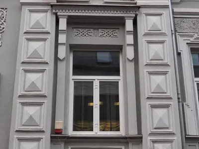 a building with a window with white trim at Vilnius street apartment in Vilnius