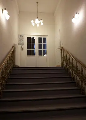 a staircase in a building with a door and lights at Vilnius street apartment in Vilnius