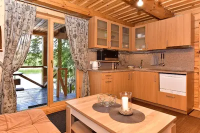 a kitchen with a table with a candle on it at Vidūnų sodyba in Kuktiškės
