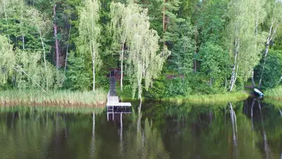 a small dock in the middle of a lake at Vidūnų sodyba in Kuktiškės