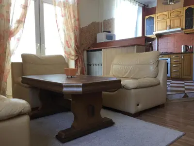a living room with a table and two chairs at Old Town apartament in Šiauliai