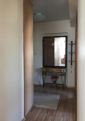 a hallway with a mirror and a table in a room at Old Town apartament in Šiauliai