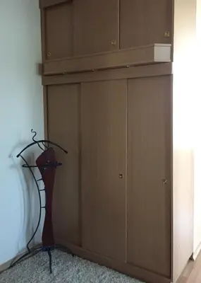 a closet with a dresser next to a door at Old Town apartament in Šiauliai