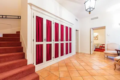 a hallway with red sliding doors in a house at Stikliai Palace Residence in Vilnius