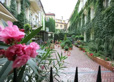 a garden with pink flowers on a brick sidewalk at Stikliai Palace Residence in Vilnius