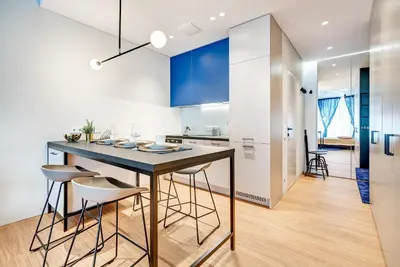 a kitchen with a table and chairs in a room at HaPPy Inn GOLD Studio, self check-in, Parking in the underground garage in Vilnius