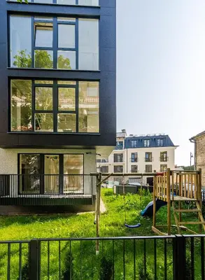 a house with a playground in front of it at HaPPy Inn GOLD Studio, self check-in, Parking in the underground garage in Vilnius