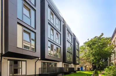an apartment building with a black and white facade at HaPPy Inn GOLD Studio, self check-in, Parking in the underground garage in Vilnius