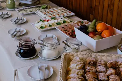 a table with a buffet of food and desserts at Green Gile Villa in Druskininkai Center in Druskininkai