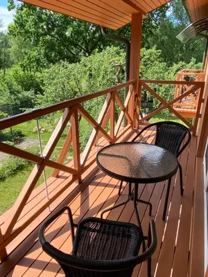 two chairs and a table on a porch at Green Gile Villa in Druskininkai Center in Druskininkai