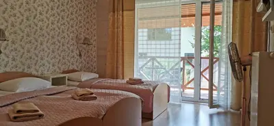 two beds in a hotel room with a window at Green Gile Villa in Druskininkai Center in Druskininkai