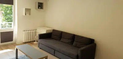 a living room with a couch and a table at City apartment Anykščiai in Anykščiai