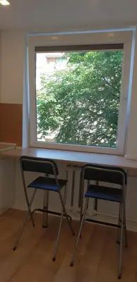 two chairs sitting in front of a window at City apartment Anykščiai in Anykščiai