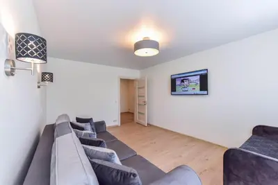a living room with a bunch of couches at Crystal Grey in Druskininkai