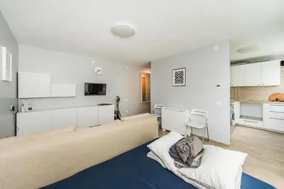 a living room with a bed and a kitchen at City break. Center in Kaunas