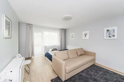 a living room with a couch and a bed at City break. Center in Kaunas