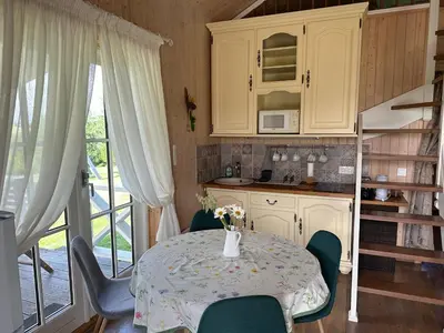 a kitchen with a table and chairs and a table and a table and a kitchen at Villa Vita in Seimėnai