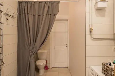 a bathroom with a toilet and a shower curtain at M terrace in Kaunas