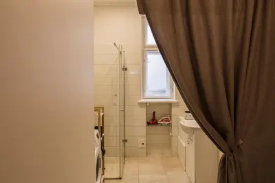 a bathroom with a shower and a toilet and a window at M terrace in Kaunas