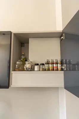 a shelf in a kitchen with jars on it at Beautiful apartment in the heart of Kaunas in Kaunas