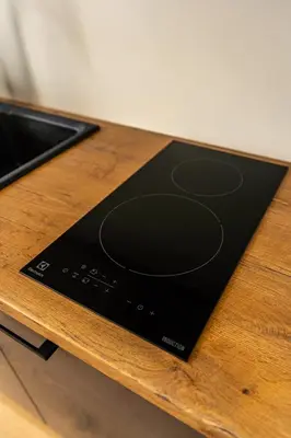 a black gadget sitting on top of a wooden table at Beautiful apartment in the heart of Kaunas in Kaunas