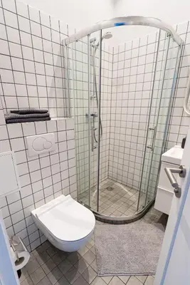 a bathroom with a shower and a toilet at Beautiful apartment in the heart of Kaunas in Kaunas