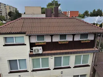 an apartment building with a brown tile roof at ApartHotel SAVAS 3 Studio and parking in Kaunas