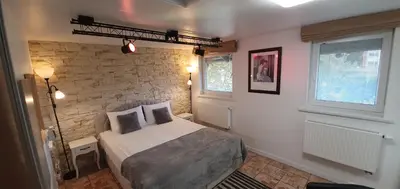 a bedroom with a bed and a brick wall at ApartHotel SAVAS 3 Studio and parking in Kaunas