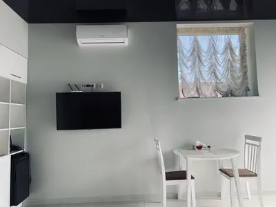a white room with a table and a window at Romeo VIP apartamentai in Panevėžys