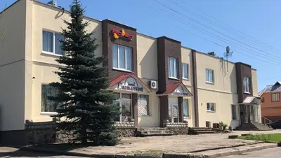 a building with a tree in front of it at Romeo VIP apartamentai in Panevėžys