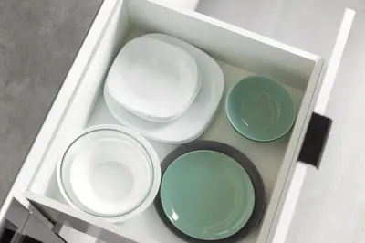 a white drawer with four plates in it at Brand New Smart House City Center in Vilnius