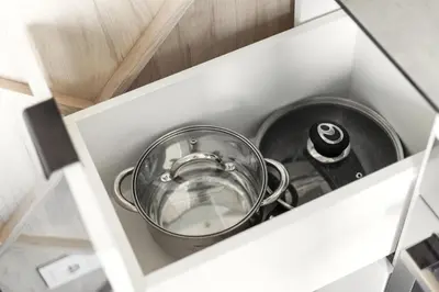a pot and pans in a kitchen drawer at Brand New Smart House City Center in Vilnius