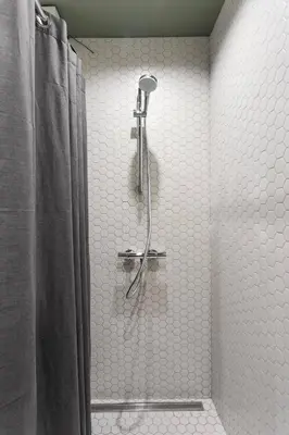 a bathroom with a shower with a shower curtain at Brand New Smart House City Center in Vilnius