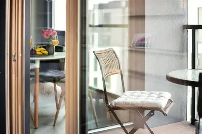 a chair sitting on a balcony next to a table at Brand New Smart House City Center in Vilnius