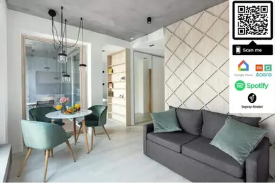 a living room with a couch and a table at Brand New Smart House City Center in Vilnius