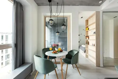 a dining room with a table and green chairs at Brand New Smart House City Center in Vilnius