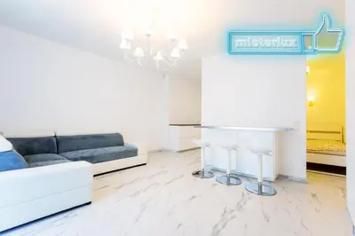 a living room with a couch and a table at Mieterlux White in Vilnius