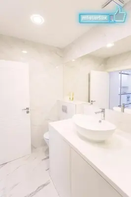 a white bathroom with a sink and a toilet at Mieterlux White in Vilnius