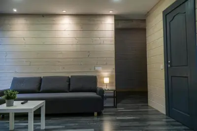a living room with a couch and a table at Du Horizontai in Molėtai