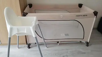 a white bed with a chair next to it at HaPPy Inn Presidential, Self check-in, Parking in the underground garage in Vilnius