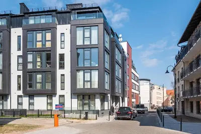 a building on a street with cars parked in front of it at HaPPy Inn Presidential, Self check-in, Parking in the underground garage in Vilnius