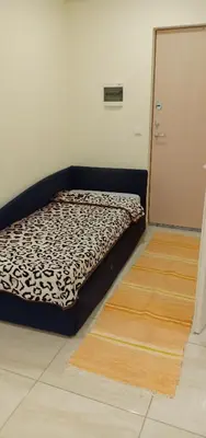 a bed sitting in a room next to a door at Kaunas Downtown Apartments in Kaunas