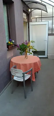 a table with a vase of flowers on it at Kaunas Downtown Apartments in Kaunas