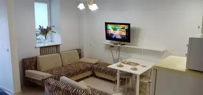 a living room with a couch and a table with a tv at Kaunas Downtown Apartments in Kaunas