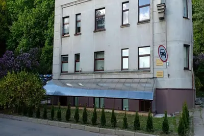 a large white building with a blue awning on it at Kaunas Downtown Apartments in Kaunas